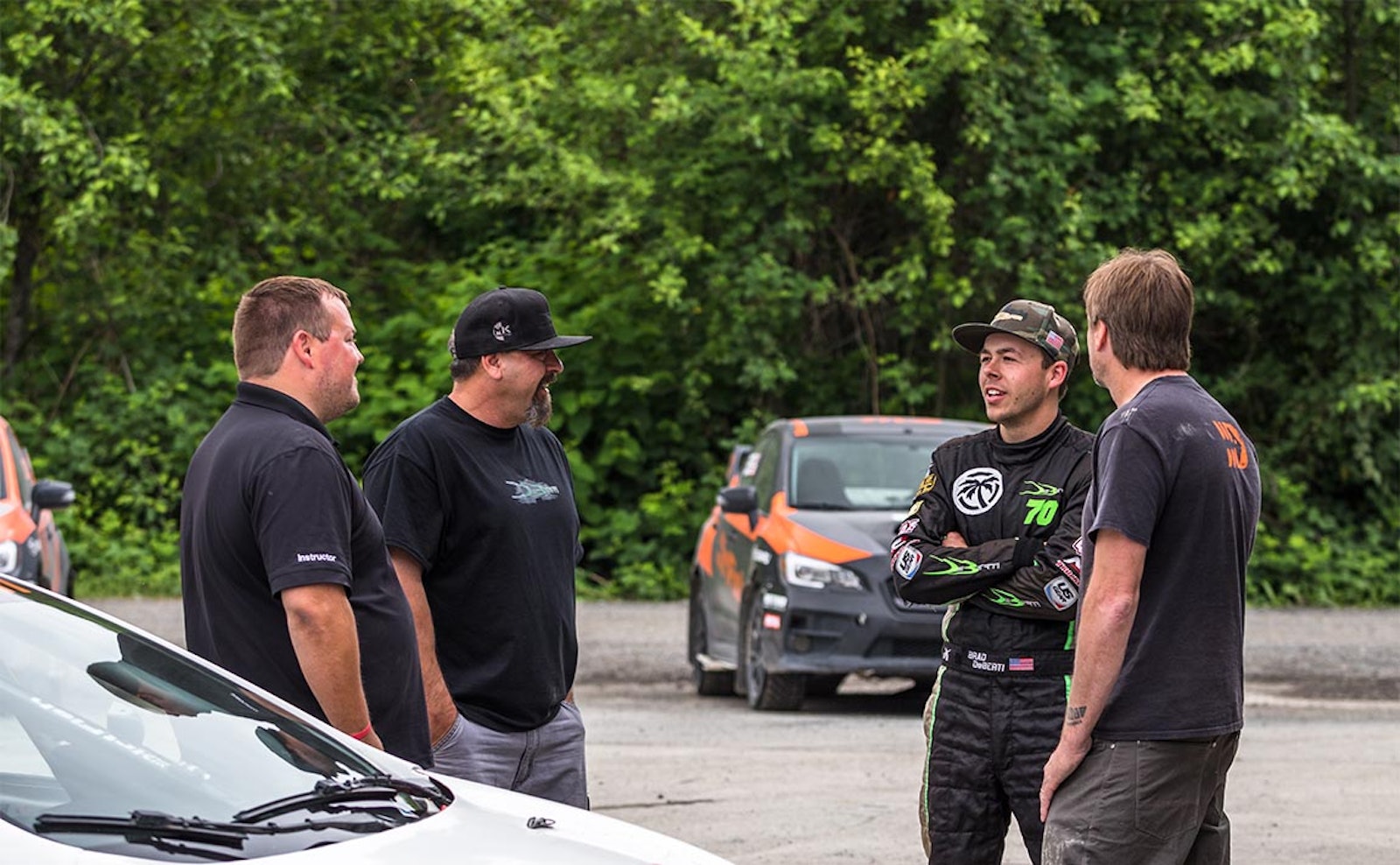 Brad DeBerti and Doug DeBerti talking with motorsports team at DirtFish